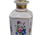 a white vase with flowers on it on a white background