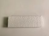 a close up of a roll of toilet paper on a white surface
