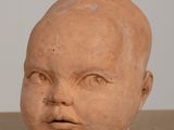 a clay head of a baby on a table