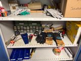a shelf full of tools and supplies in a room