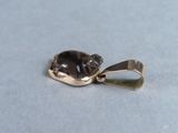a picture of a gold pendant with a black cat on it