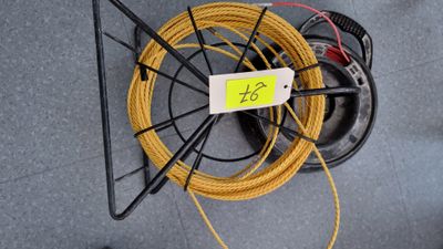a wire that is attached to a wall with a tag