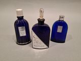 three bottles of perfume sitting next to each other on a table