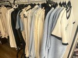 clothes hanging on a rack in a clothing store