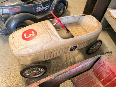 a toy car that is sitting on the floor next to other toy cars
