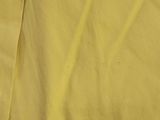 the back of a women ' s yellow skirt with a zipper on the side