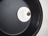 a close up of a black pan with a white label on it