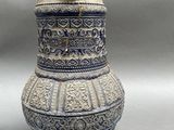 a blue and white vase with a lid sitting on a table
