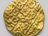 an image of a gold coin with arabic writing on it