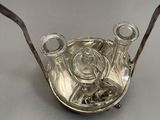 a silver plate with a teapot and two glasses on it