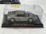a silver toy car in a clear box on a table