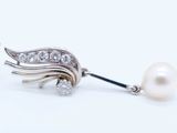 an image of a pair of pearl and diamond earrings on a white background