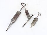 two old metal tools are laying on a white surface
