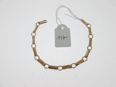 gros plan d'un bracelet en or portant une étiquette de prix