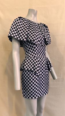 the mannequin is wearing a black and white dress with polka dots