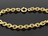 a gold chain bracelet on a black surface