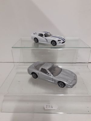 two toy cars on display in a clear display case