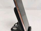 a cell phone that is sitting on top of a stand