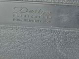 a close up of a metal plate with a name on it