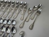 a lot of silver spoons and spoons on the table