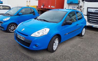 two blue cars parked next to each other in a parking lot