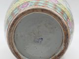 a close up of a vase on a white surface