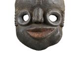 a close up of a wooden mask on a white background