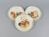 three plates with a picture of people on them on a gray surface