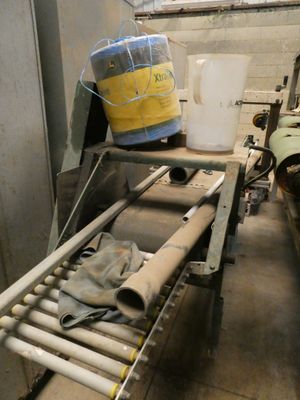 un tapis roulant sur lequel est posé un seau d'eau