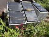 a pile of old suitcases sitting on the side of the road