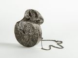 a silver purse with a chain around it on a white surface