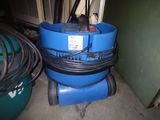 a blue machine that is sitting on the floor