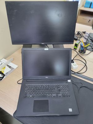 a laptop computer sitting on top of a desk next to a monitor