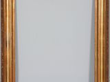 an antique gold frame with a white background