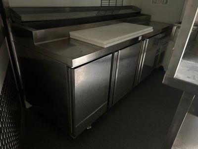 a kitchen with stainless steel cabinets and a counter top