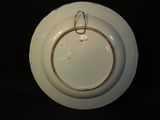 a white plate with a ring on it sitting on a table