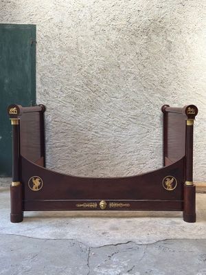 a bed that has a wooden frame on the side of it