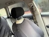 a picture of a dirty car with a seat cover on