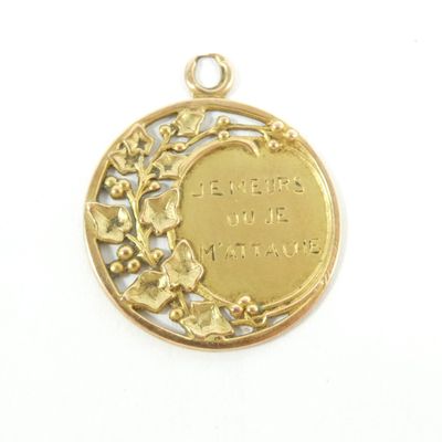 an image of a gold plated pendant with a quote on it