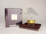 an image of a bottle of perfume next to a box of perfume