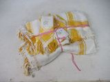 a yellow and white towel with a tag on it