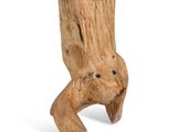 a wooden sculpture of a tree stump with a face on it