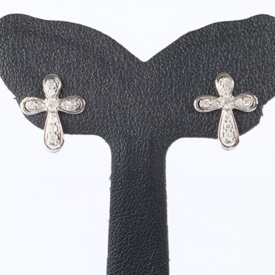 pair of diamond cross earrings on a black leather surface