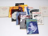 several books are arranged on a white surface with a white background
