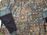 a close up of a shirt with a paisley pattern on it