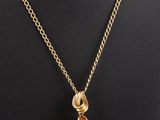 a gold plated necklace with a tear shaped citrine stone