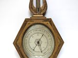 an old clock with a harp hanging on a wall