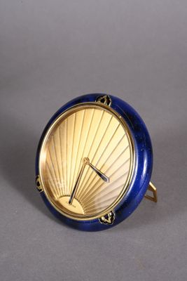 a small clock that is sitting on top of a table