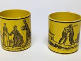 pair of yellow and black mugs with images of people on them