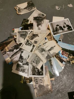 a pile of old photos on the floor of a room